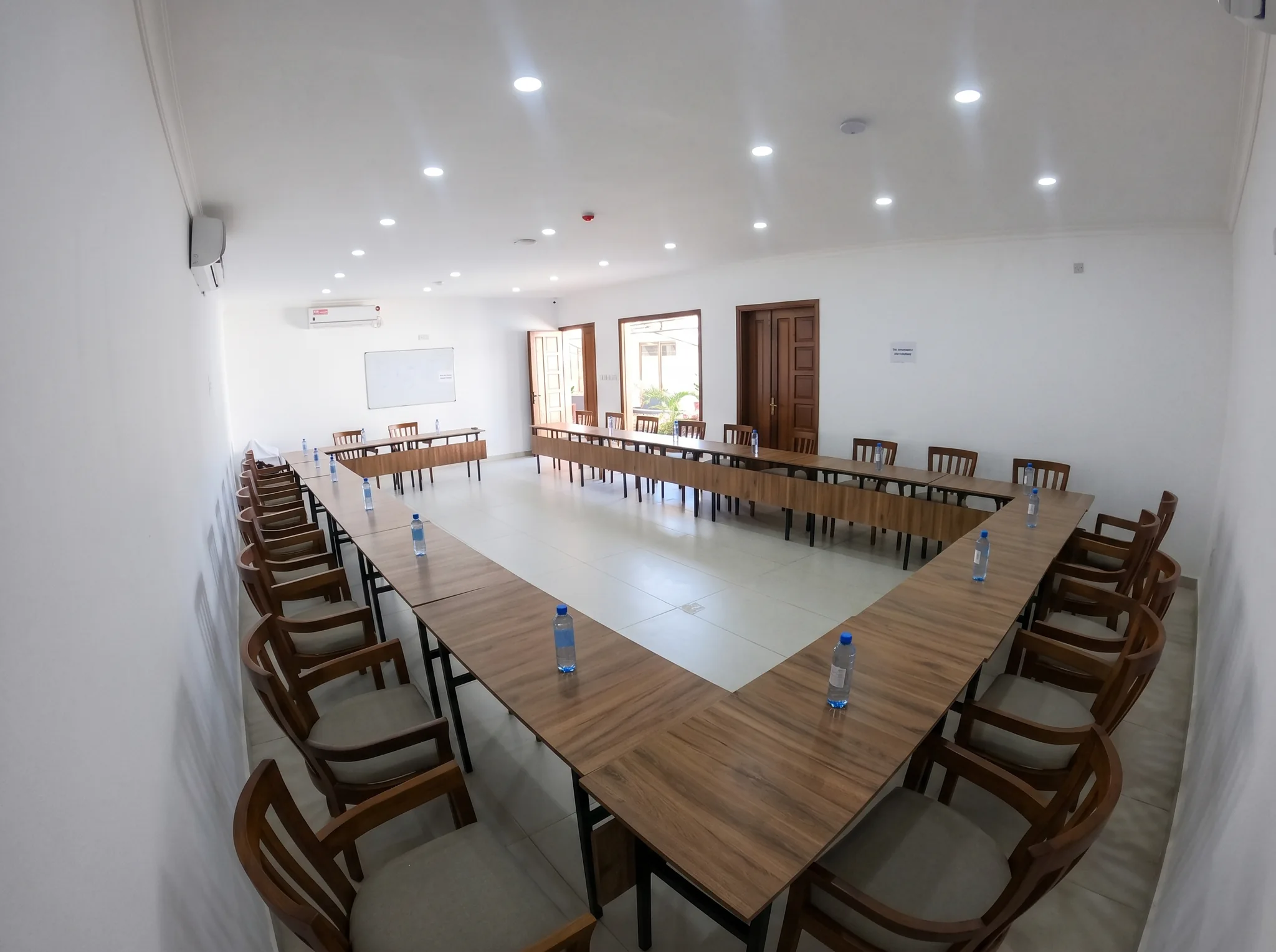Corporate conference seminar hall wide setup with presentation boards and tables at Diani Darling