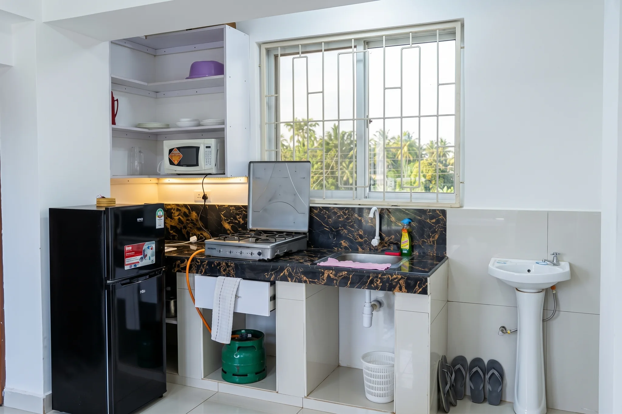 Self-catering private kitchenette with cabinets and cooking area at Tower Cottages