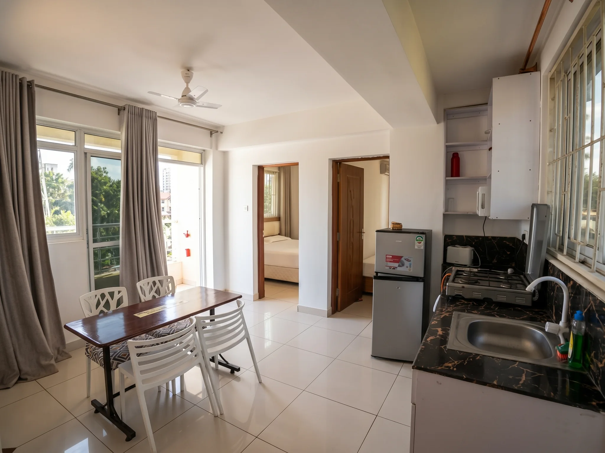 Spacious furnished living room with sofa set and natural coastal light at Tower Cottages