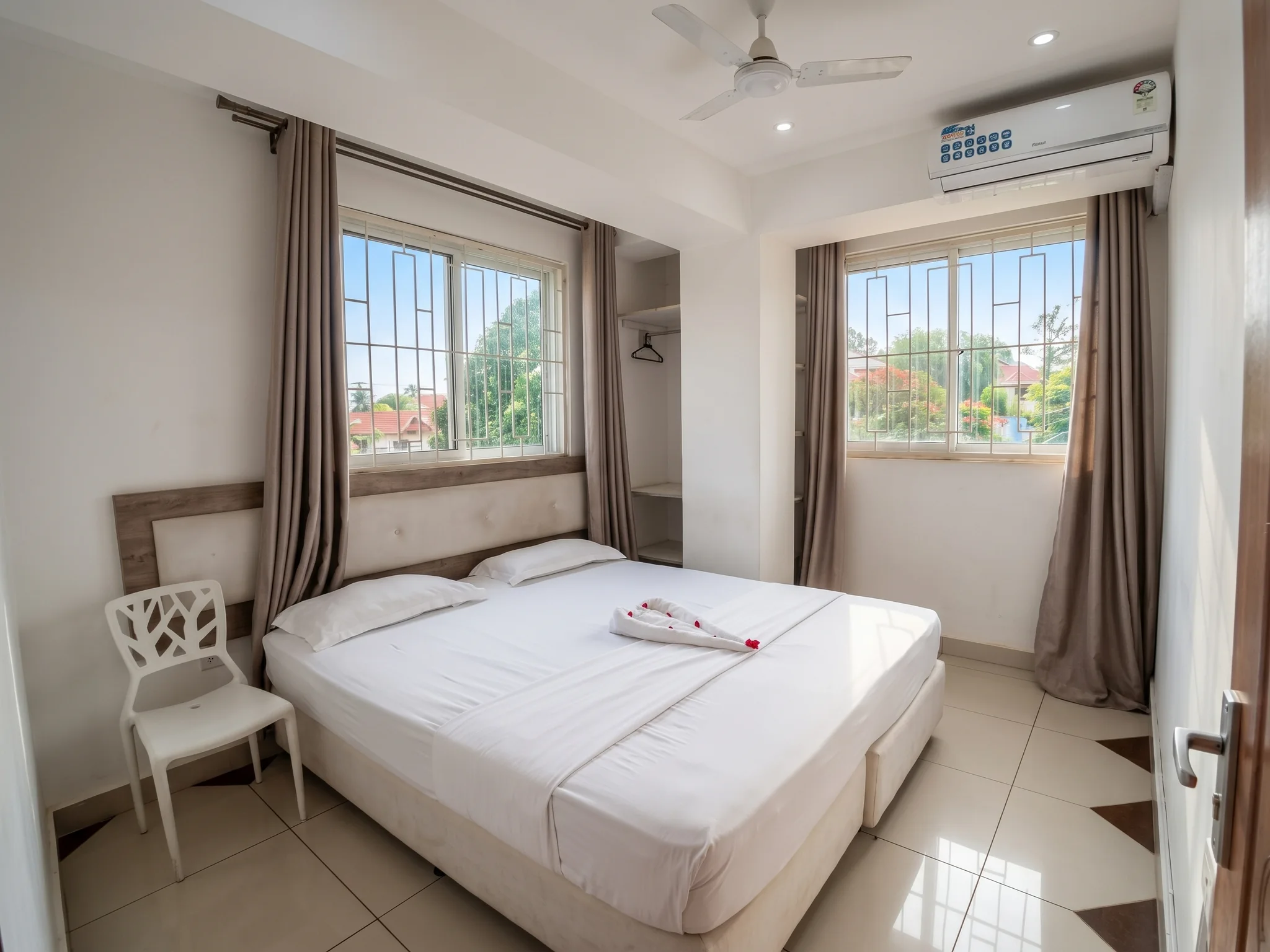 Master bedroom with wooden double bed and mosquito net at Tower Cottages Ukunda